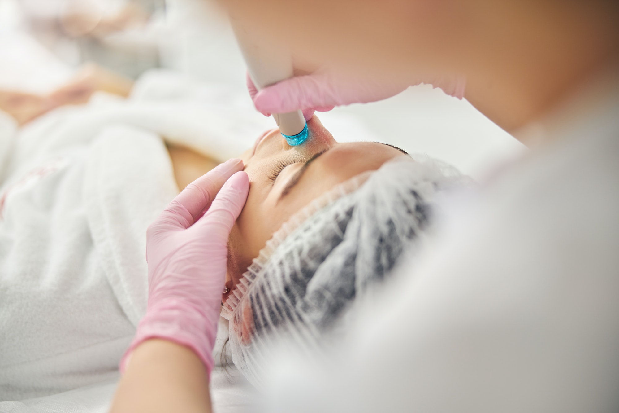 Young Caucasian female undergoing a dermatological procedure